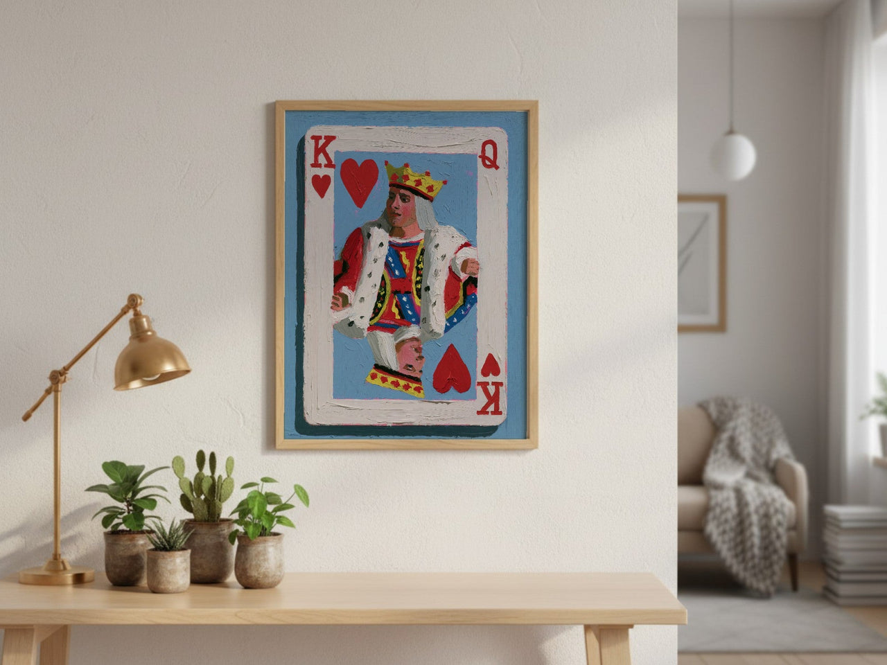 King of Hearts framed art above a console table